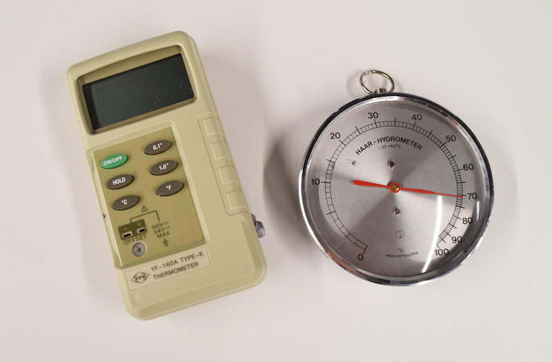 An electronic thermometer and dial hygrometer. 